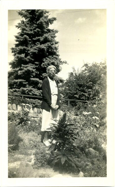 Phoebe Watson standing in her garden, c.1941. HWHG Permanent Collection.